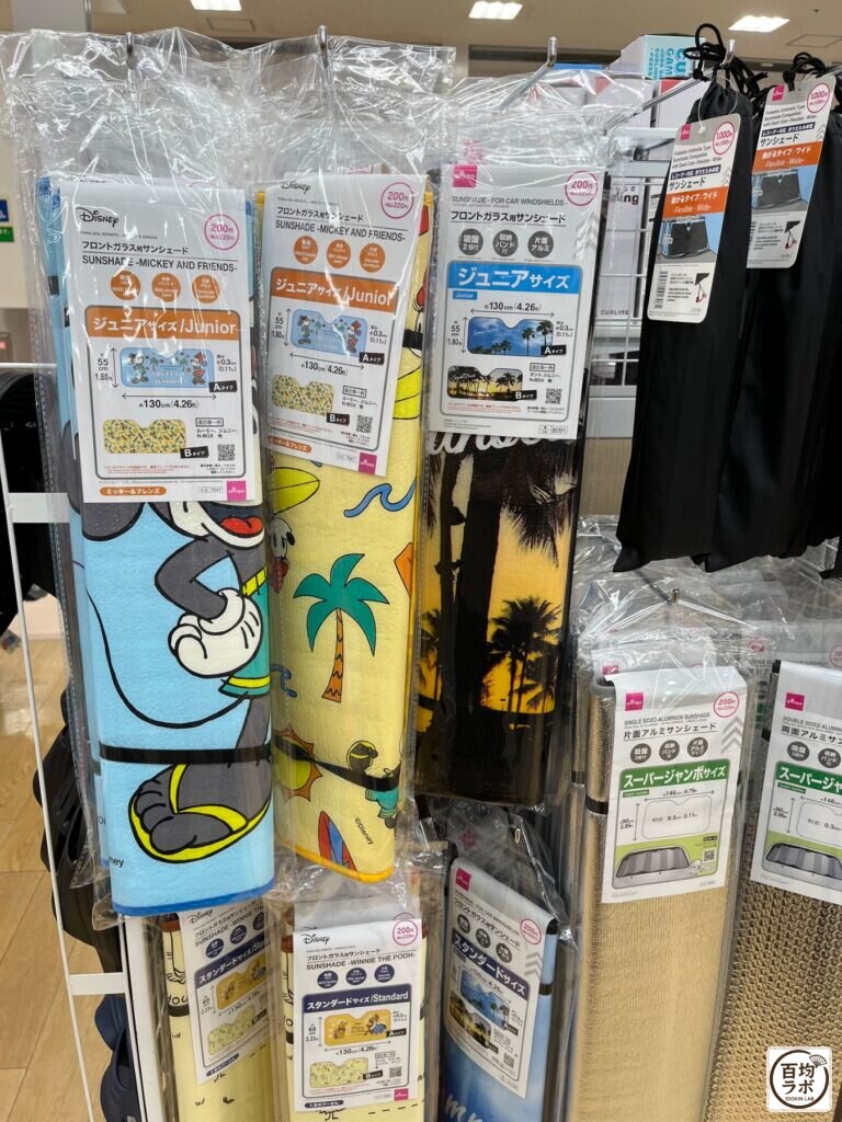 ダイソー 東戸塚の収納売り場に並ぶフロントガラス用サンシェード（ミッキー＆フレンズ・ジュニアサイズ）、フロントガラス用サンシェード（ジュニアサイズ）など計6商品（2026年8月11日撮影）